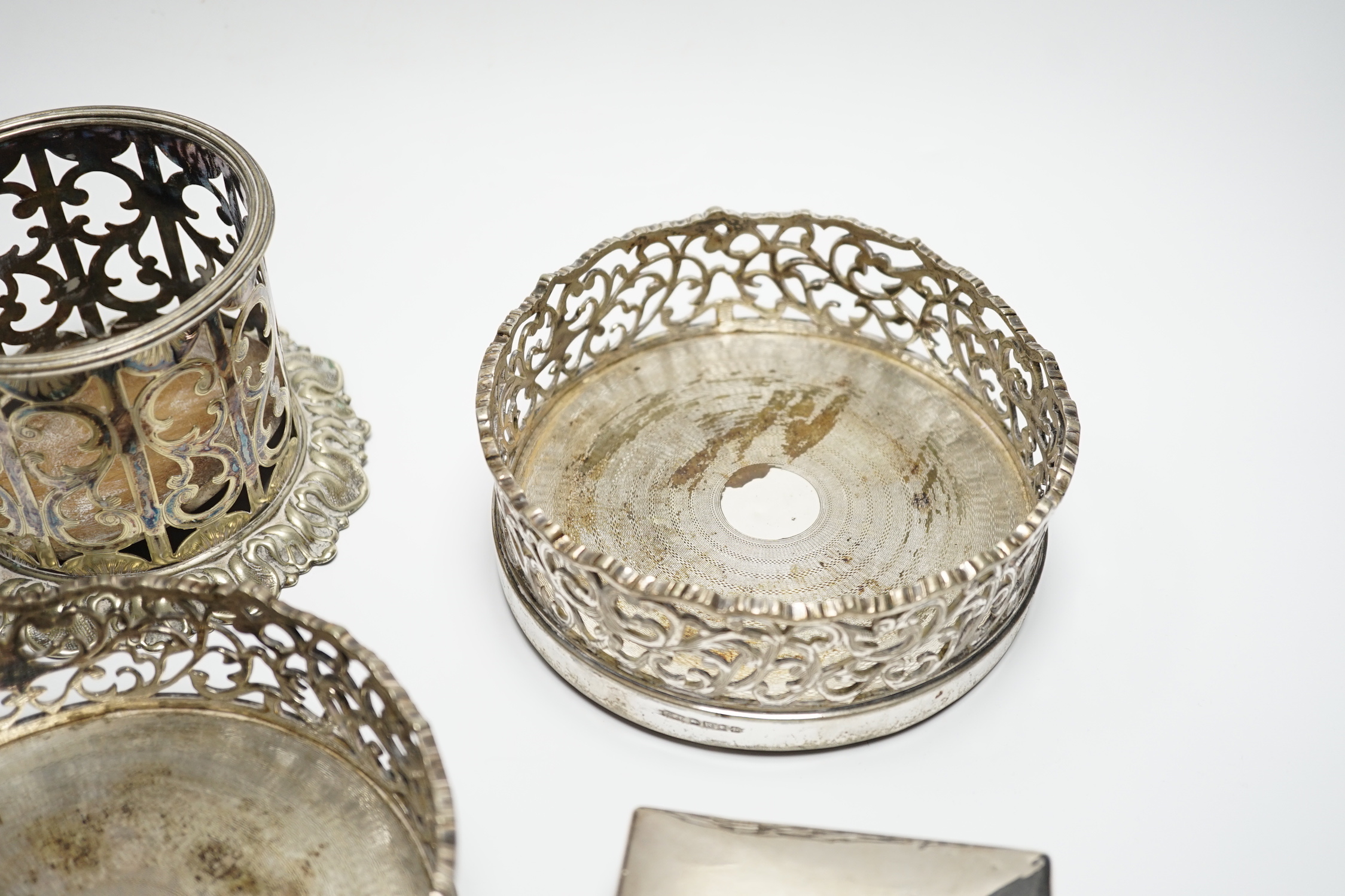 A George V silver cigarette case, 82mm, a similar silver mounted cigarette box, a modern silver mounted small wine coaster and three silver plated wine coasters including a pair.